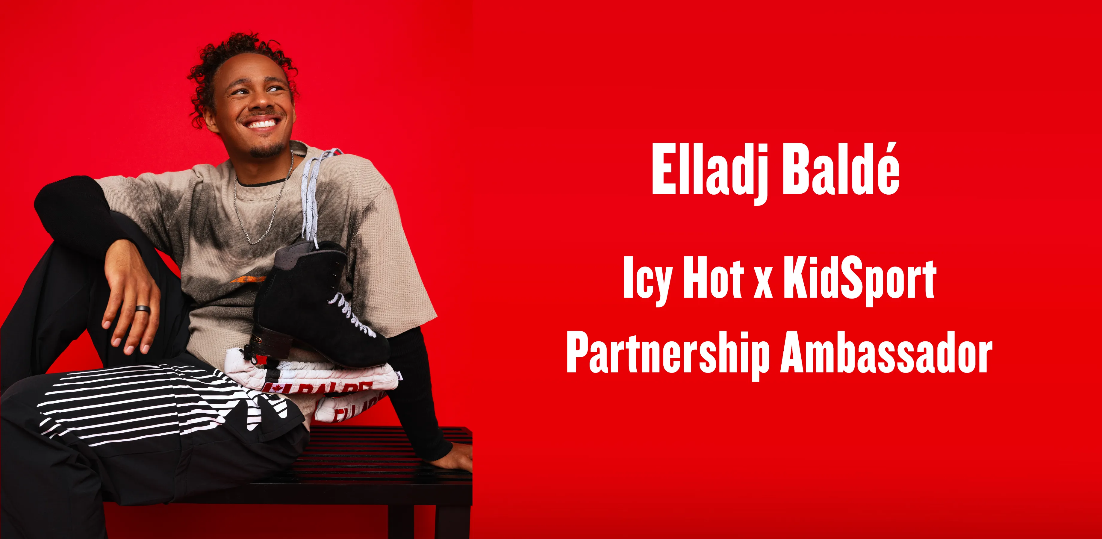 A man holds a football, and looks over his shoulder.